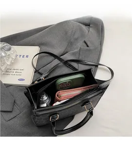 Top view of black monogram crossbody bag interior showing spacious storage for daily items