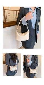 Close-up of cream white lychee texture leather hobo bag with adjustable strap and metal buckle