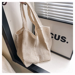 Détail du sac fourre-tout beige en maille ajourée avec texture crochet minimaliste