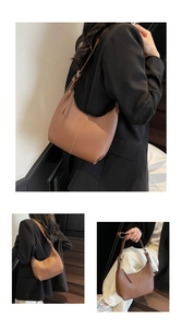 Detail view of dark brown leather hobo bag with half-moon shape and adjustable strap