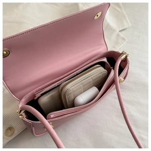 Pink crossbody bag interior view showing zipper compartment and daily essentials capacity
