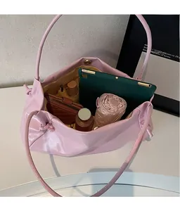 Spacious interior of pink leather tote bag showing storage for tablet, umbrella, and wallet