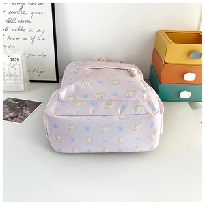Pink backpack for students featuring a cute cat and bow print with front zipper pocket