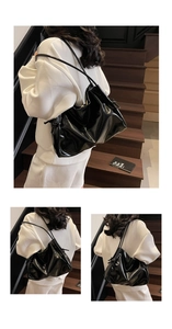 Close-up of black glossy patent leather tote bag with stylish shoulder straps on a model