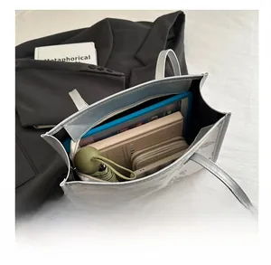 Top view of spacious interior of silver-grey butterfly tote bag with daily essentials