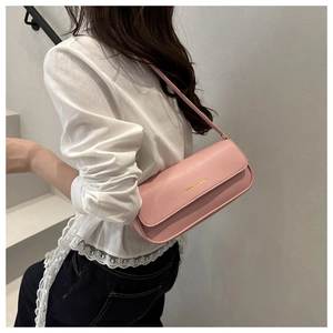 Detail view of pink leather shoulder bag with gold 'FASHION & BAGS' text for women