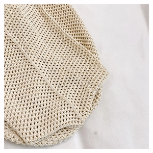 Detailed macro view of the beige hollow out crochet knit pattern on a large tote bag
