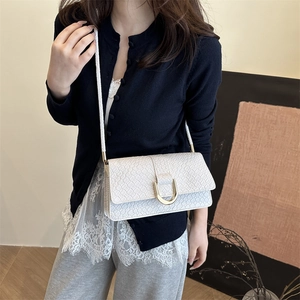 White crocodile pattern shoulder bag with a gold U-shaped buckle in a minimalist design