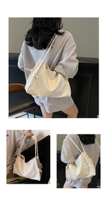Detail of white patent leather tote bag showing side knot design and slim shoulder strap