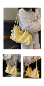 Detail of yellow glossy leather tote bag with stylish side drawstring knot decoration