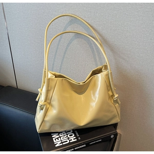 Detail of yellow soft PU leather tote bag with stylish drawstring knots on side
