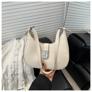 Close-up of cream underarm bag with silver geometric buckle and adjustable shoulder strap