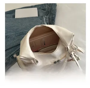 Interior view of the cream white tote bag showing large capacity for books and wallet