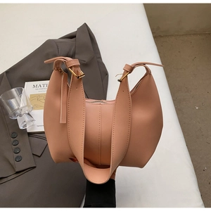 Detail of nude pink half-moon shoulder bag with wide strap and minimalist stitching