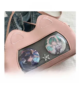 Detail of pink cat-shaped ita bag with clear window and silver star metallic accents