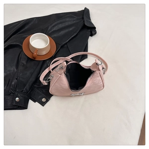 Detail view of pink bow handbag with silver metallic ribbon and a black inner lining