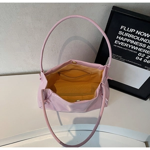 Overhead view of pink leather tote bag showing spacious interior with yellow lining