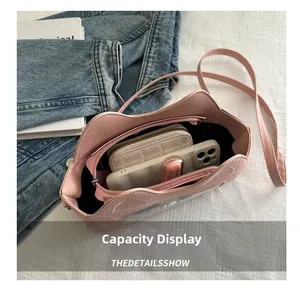 Pink cat-ear cylindrical bag capacity display with smartphone and makeup inside