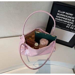 Spacious interior of a pink leather tote bag showing storage for a tablet and umbrella