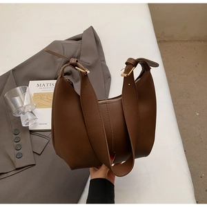 Detailed view of large dark brown hobo shoulder bag with matte leather finish and gold buckle