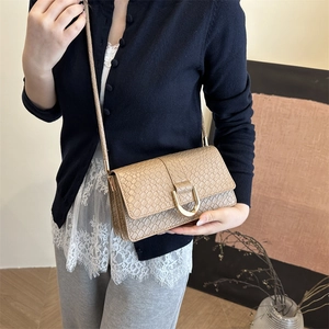 Beige faux snake skin shoulder bag with gold horsebit buckle detail in a minimalist design