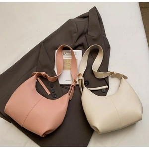 Close-up of matte PU leather half-moon hobo bags with adjustable straps in pink and beige
