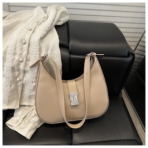 Detail view of beige hobo shoulder bag with matte finish and silver square rotating buckle