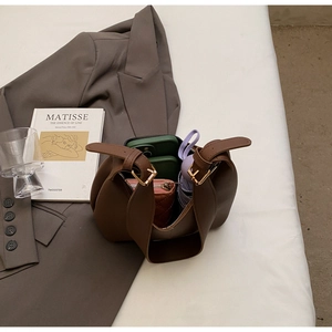 Detail view of large dark brown tote bag interior capacity with everyday essentials