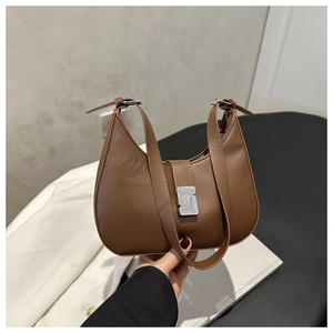 Detail of a brown leather hobo bag with a silver geometric buckle and double strap design