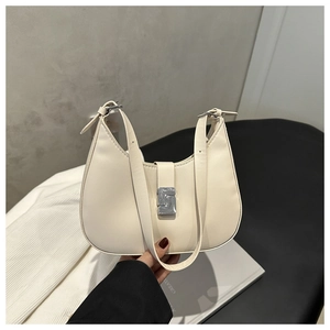 Detail of cream hobo bag with adjustable strap and silver metal buckle closure