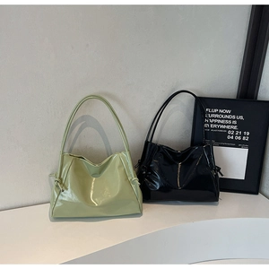 Detail of minimalist glossy tote bags in black and green with knotted side decor