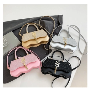 Detail of glitter patchwork crossbody bags with wave edges and gold metal SS logo