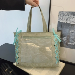 Light green pleated tote bag with clear window and blue ribbon lace-up details