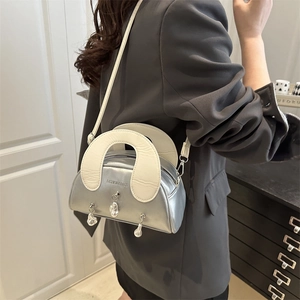 Silver metallic shell handbag with white handle and hanging water drop charms for women