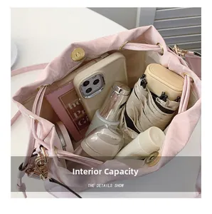 Interior view showing the large capacity of the pink drawstring bucket bag with daily items