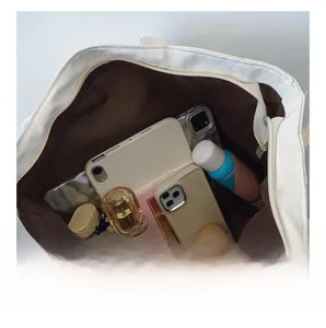 Detailed view of the white tote bag interior showing large capacity for daily items