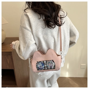 Pink cat-eared ita bag with transparent window featuring anime badges shown on shoulder