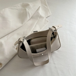 Minimalist beige underarm shoulder bag with adjustable strap and spacious interior