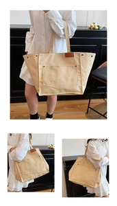 Gros plan du sac fourre-tout en toile beige avec poche frontale, rivet et détail cuir
