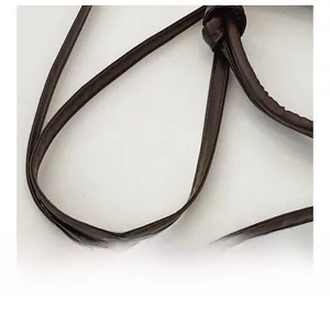Close-up of a dark brown PU leather bag strap featuring a stylish decorative knot detail