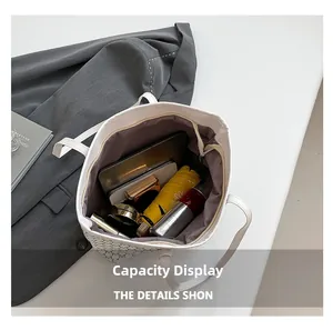 Spacious interior of a white patterned tote bag showing laptop and daily essentials