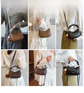Detail of half-moon crossbody bags in black and brown with plush monster charms