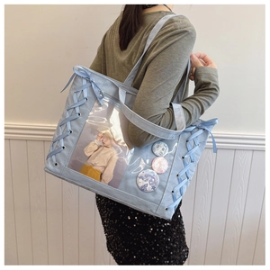 Detail view of light blue tote bag with transparent window and ribbon weaving
