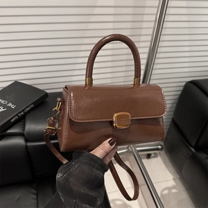 Vintage brown leather crossbody bag with top handle and gold metal buckle for women