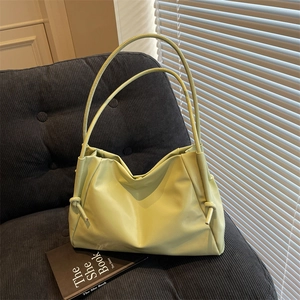 Minimalist avocado green tote bag with pleated leather texture and knotted straps