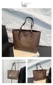 Detail of coffee brown tote bag featuring M-pattern monogram and gold metal charm