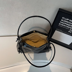 Large capacity black glossy tote bag with yellow interior and secure magnetic closure