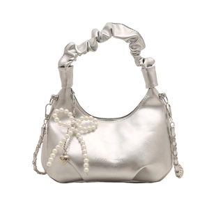 Silver metallic hobo bag with pearl bow charm and ruched top handle on white background
