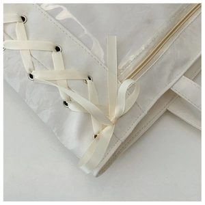 Detail of white ita bag showing high-quality ribbon lacing and transparent PVC window