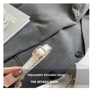 Detail of adjustable silver strap with premium golden metal buckle on a shoulder bag
